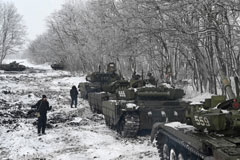 Russian service members gather near armored vehicles during drills held by the Southern Military District at the Kadamovsky range in the Rostov region, January 27, 2022. (REUTERS/Sergey Pivovarov)