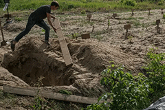 A gravedigger working at a site where 30 unidentified bodies were buried last week in Bilohorodka, near Kyiv.Credit...Mauricio Lima for The New York Times