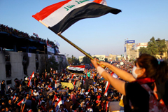 A protester waves an Iraqi flag during an anti-government demonstration in Baghdad on Nov. 1, 2019. (Ahmed Jadallah/Reuters)