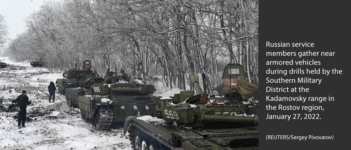 Russian service members gather near armored vehicles during drills held by the Southern Military District at the Kadamovsky range in the Rostov region, January 27, 2022. (REUTERS/Sergey Pivovarov)