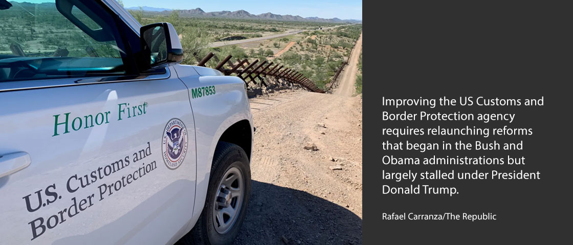 The passenger side door of a US Customs and Border Protection vehicle in the dessert