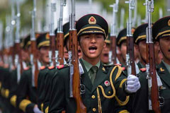 Chinese soldiers in formation with rifles marching