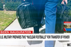 Screenshot of CNN video with person carrying the bags containing the US Nuclear Football