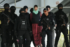  Doan Thi Huong is escorted by Malaysian police out of the high court in Shah Alam on 1 April. Photograph: AFP Contributor#AFP/AFP/Getty Images 