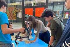 Irene Terpstra (center, leaning over table) teaching students in Spain