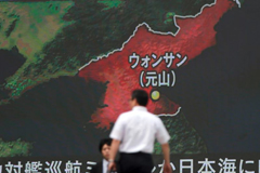  FILE - A screen shows a news program reporting in Tokyo about North Korea's missile firing from Wonsan, center, June 8, 2017. 