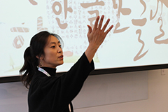 Woman in traditional Korean dress teaching Korean