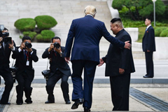 President Donald Trump steps into the northern side of the Military Demarcation Line that divides North and South Korea, as North Korea's leader Kim Jong Un looks on, in the Demilitarized zone (DMZ), June 30, 2019.