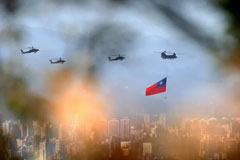 Military helicopters, one trailing a Taiwan flag, rehearse for Taiwanese national day celebrations. Photograph: Daniel Ceng Shou-Yi/ZUMA Press Wire/REX/Shutterstock