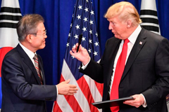  US President Donald Trump and South Korean President Moon Jae-in sign a trade agreement at a bilateral meeting in New York on September 24, 2018, a day before the start of the General Debate of the 73rd session of the General Assembly.  Nicholas Kamm / AFP/Getty Images