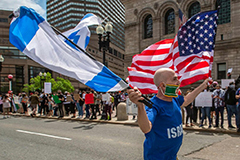 A man waving the flags of Israel and the United States in front of a rally in support of Palestine last week in Copley Square in Boston.