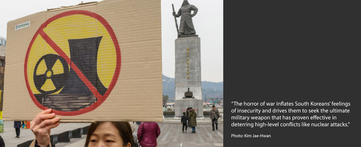 A South Korean environmental activist holds a banner during the anti-nuclear and anti-fossil energy rally at Gwanghwamun Square in central Seoul on 11 March 11, 2024